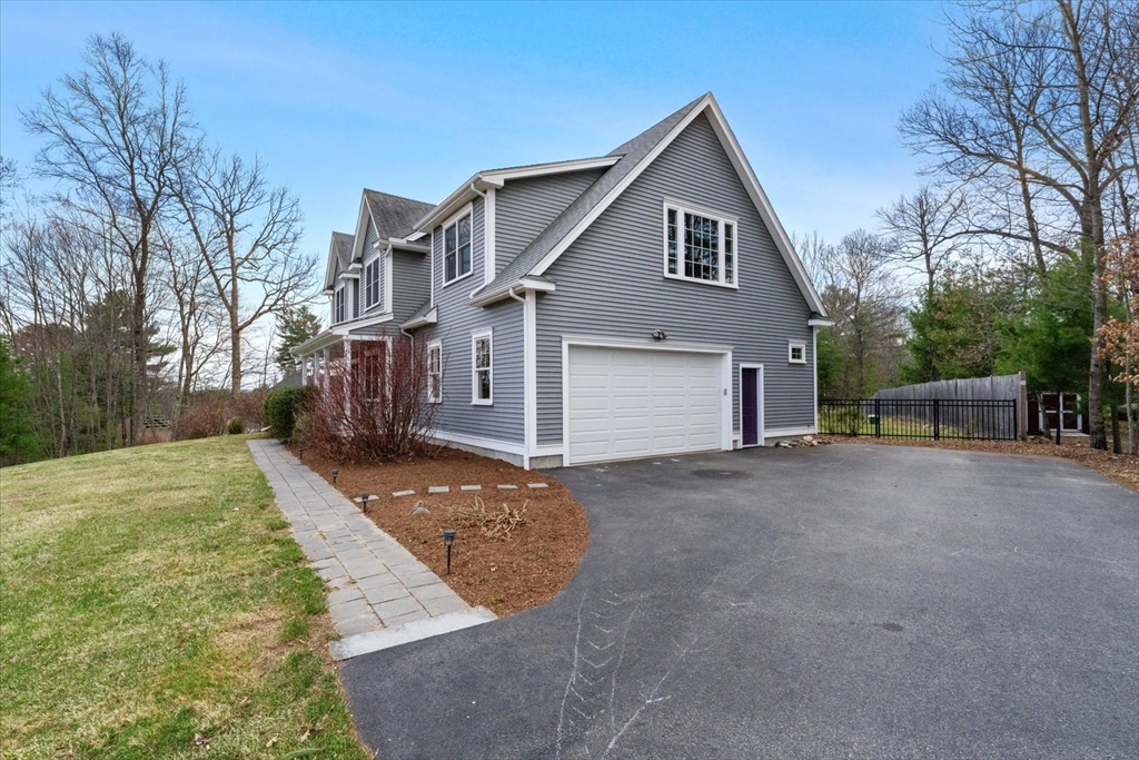 50 Quabbin Path Sutton, MA 01590 - Photo 4 of 42 a front view of a house with a yard and garage