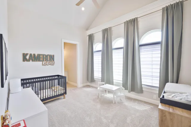 a spacious bedroom with a bed and a large window