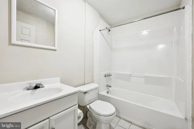a bathroom with a sink toilet vanity and shower