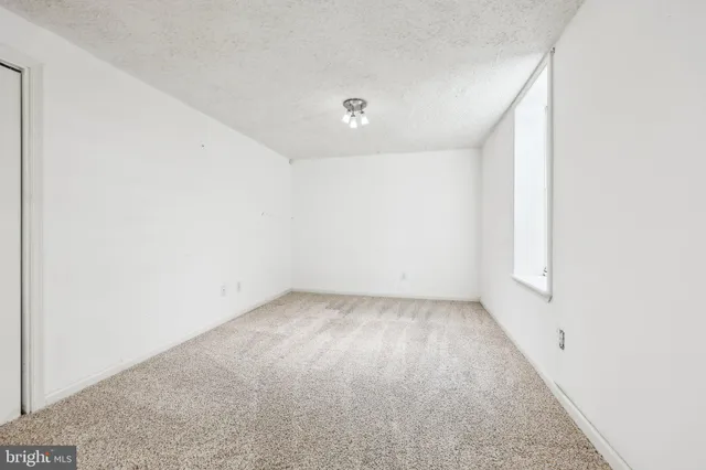 an empty room with a empty space and windows
