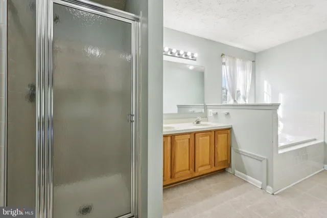 a spacious bathroom with a double vanity sink and a mirror