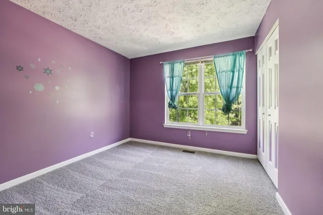 a view of a livingroom with an empty room and window