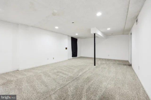 a hallway with sliding door and wooden door