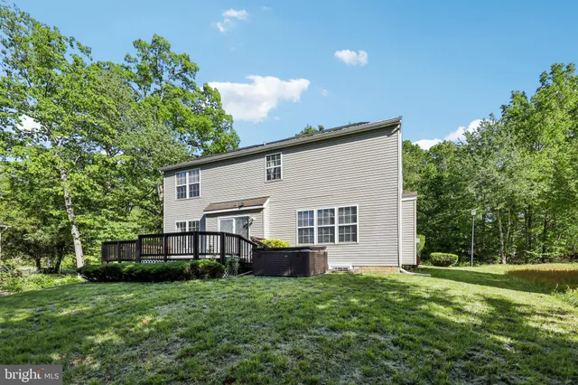a view of a house with a big yard and potted plants