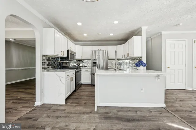 a view of kitchen with white cabinets
