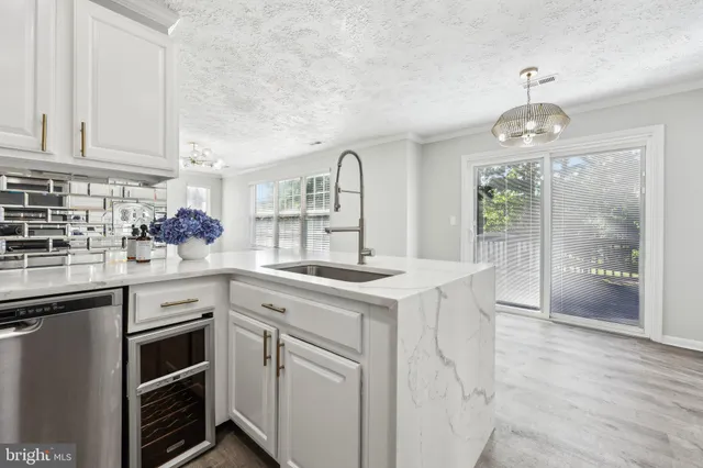a kitchen with white cabinets and white appliances