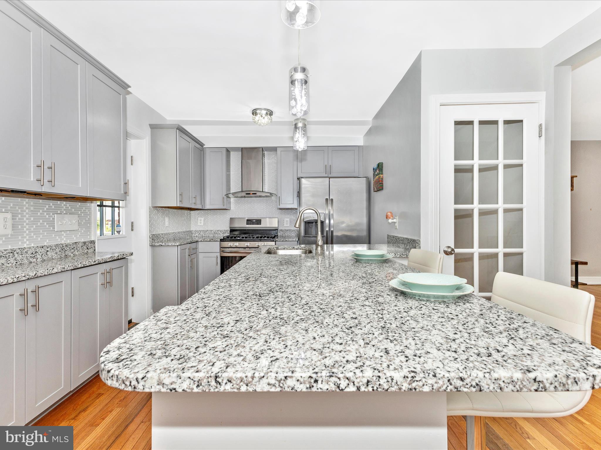 507 Kerwin Court Silver Spring, MD 20901 - Photo 11 of 51 a kitchen with kitchen island granite countertop a sink stove and refrigerator