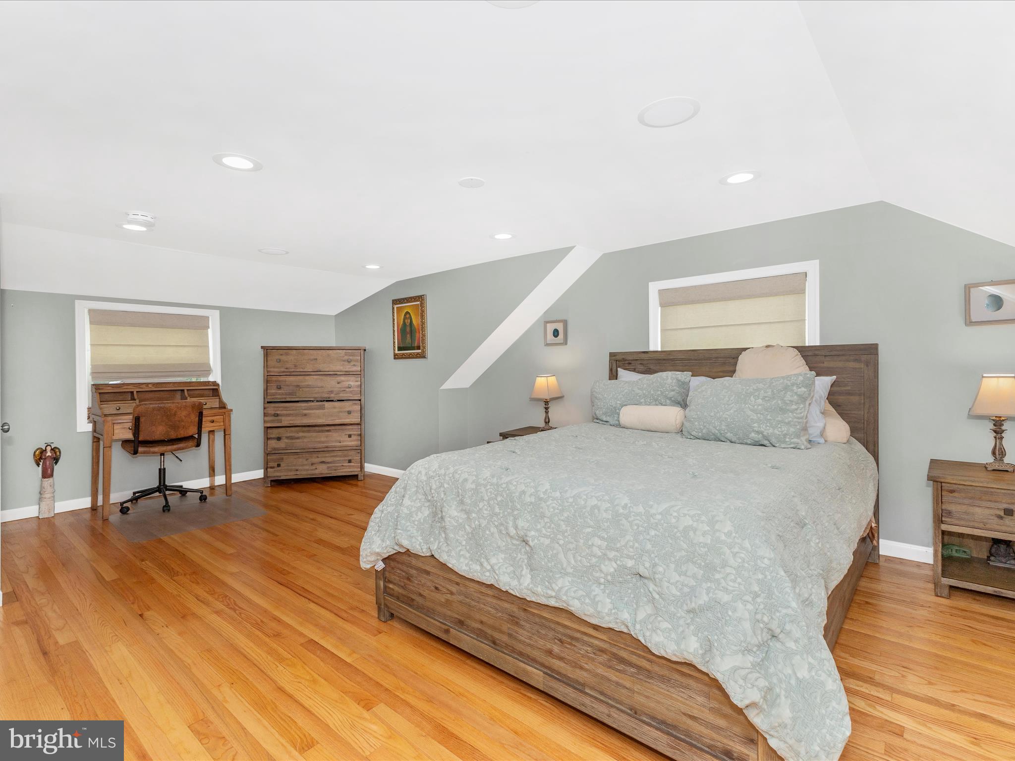 507 Kerwin Court Silver Spring, MD 20901 - Photo 16 of 51 a spacious bedroom with a bed and a table in it