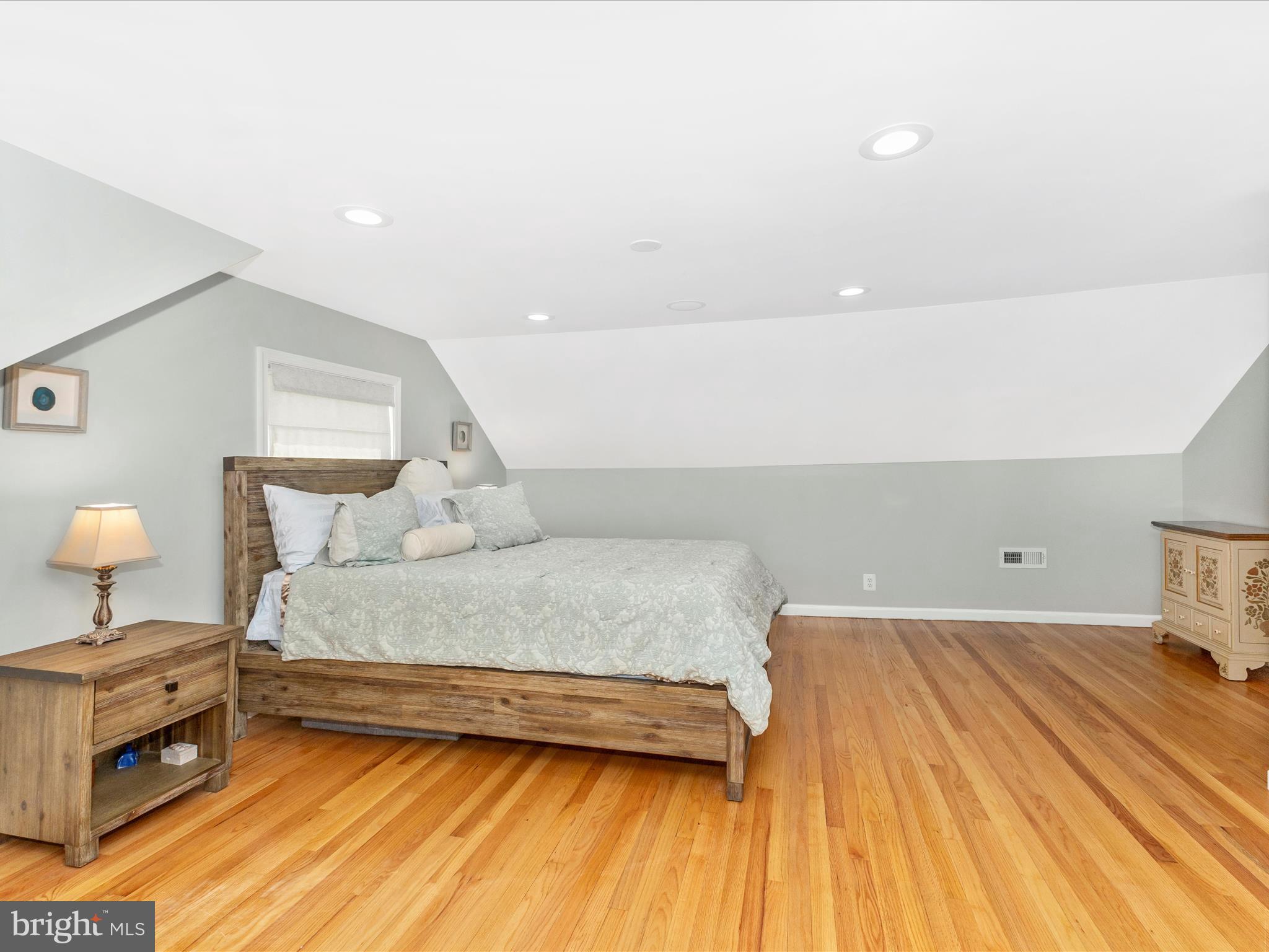 507 Kerwin Court Silver Spring, MD 20901 - Photo 18 of 51 a spacious bedroom with a bed and a lamp on dresser