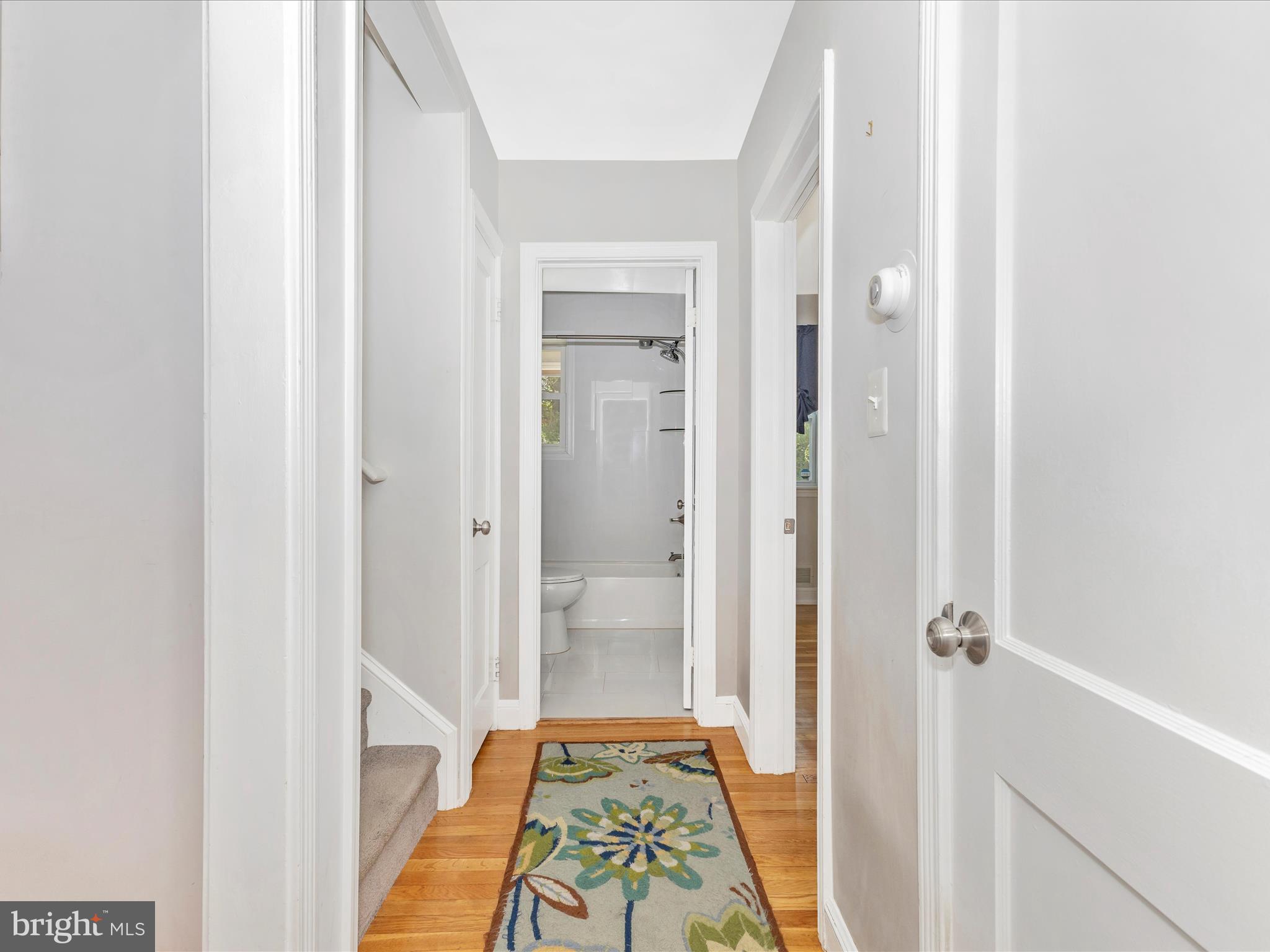 507 Kerwin Court Silver Spring, MD 20901 - Photo 23 of 51 a view of a hallway with wooden floor and a bathroom