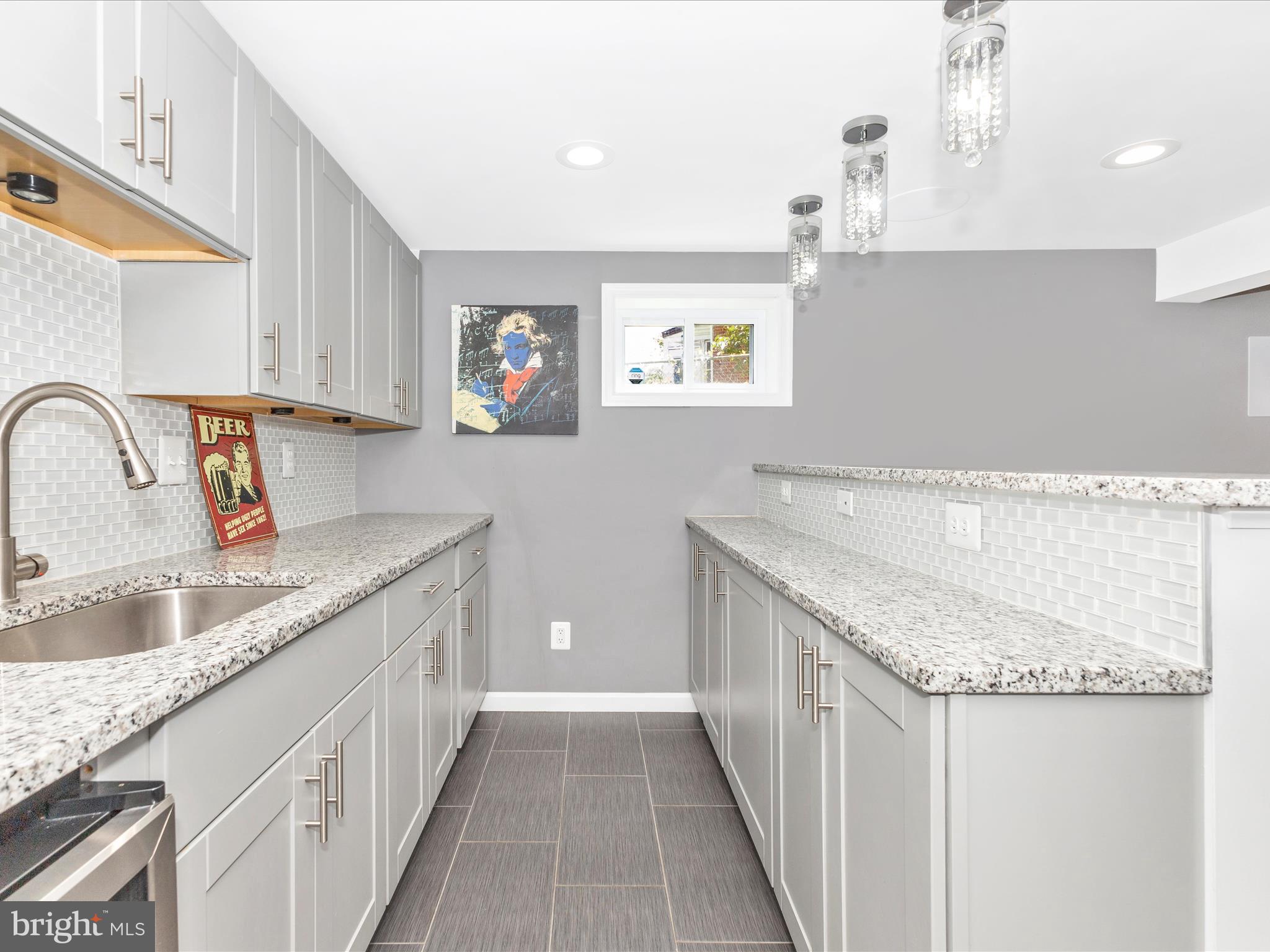 507 Kerwin Court Silver Spring, MD 20901 - Photo 32 of 51 a kitchen with a sink stove and cabinets