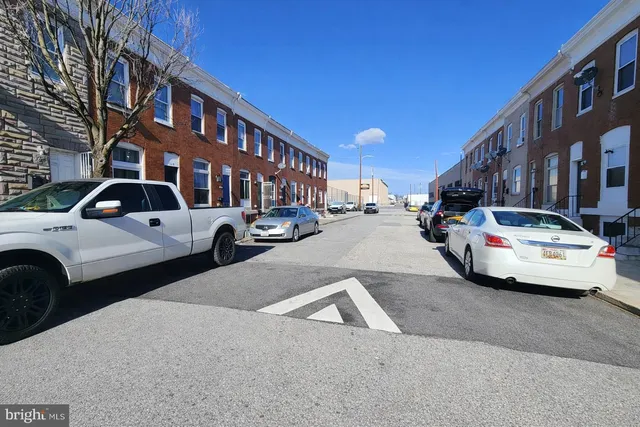 a view of a cars park in front of a building
