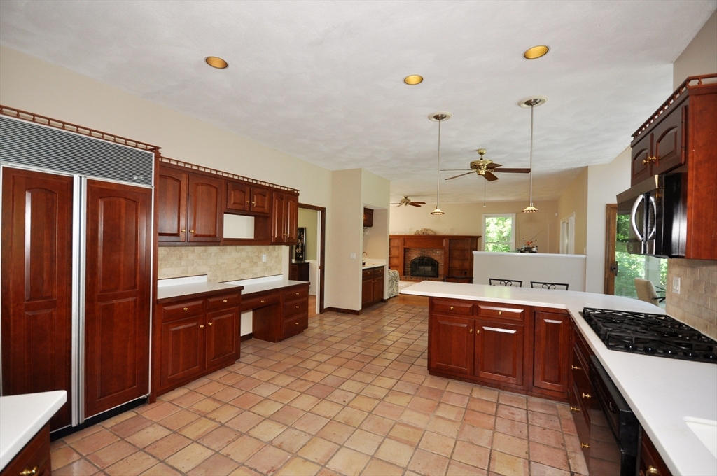 9 Breezy Point Road Acton, MA 01720 - Photo 11 of 37 a large kitchen with cabinets and stainless steel appliances