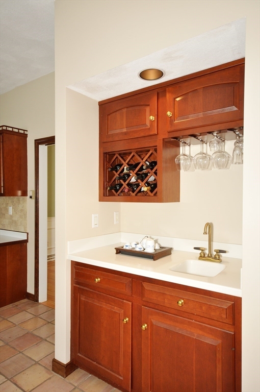 9 Breezy Point Road Acton, MA 01720 - Photo 12 of 37 a bathroom with a sink a mirror and a painting on the wall