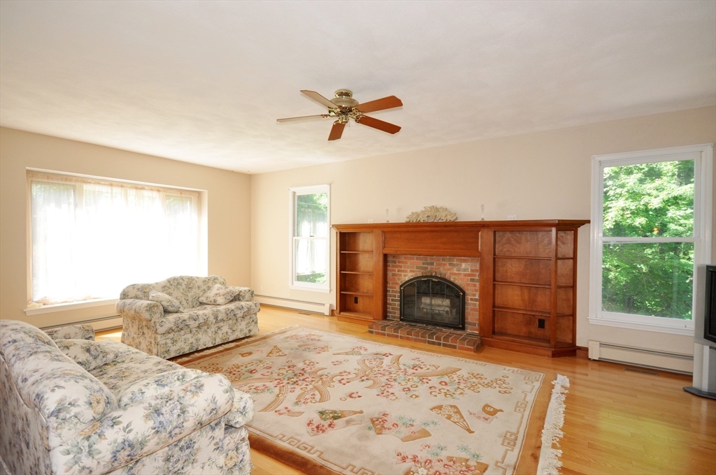 9 Breezy Point Road Acton, MA 01720 - Photo 14 of 37 a bedroom with a bed and a fireplace