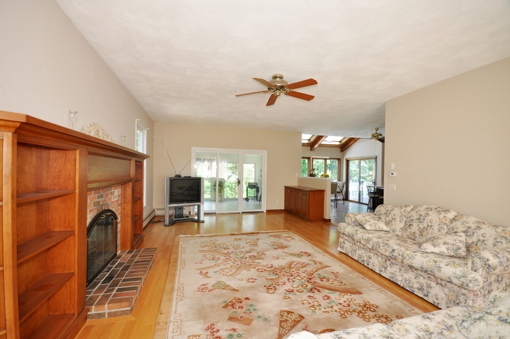 9 Breezy Point Road Acton, MA 01720 - Photo 15 of 37 a view of a livingroom with furniture and a flat screen tv