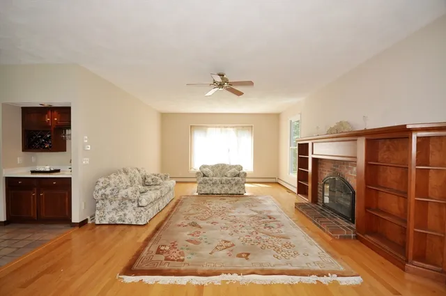a living room with furniture fireplace and flat screen tv