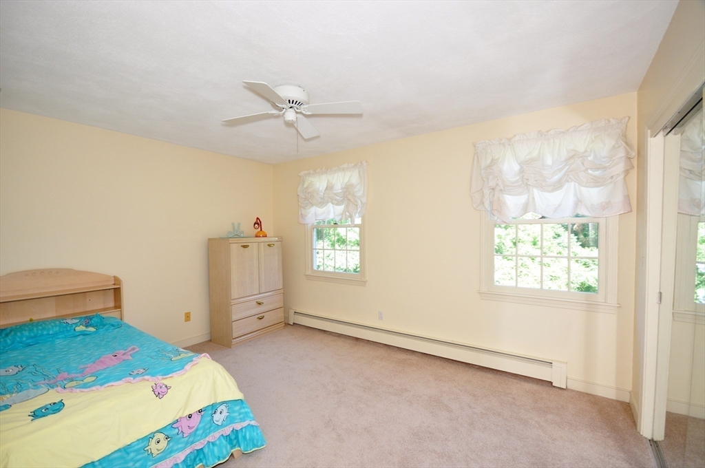 9 Breezy Point Road Acton, MA 01720 - Photo 27 of 37 a bedroom with a bed and a window