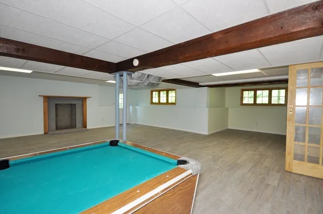 a room with pool table and windows