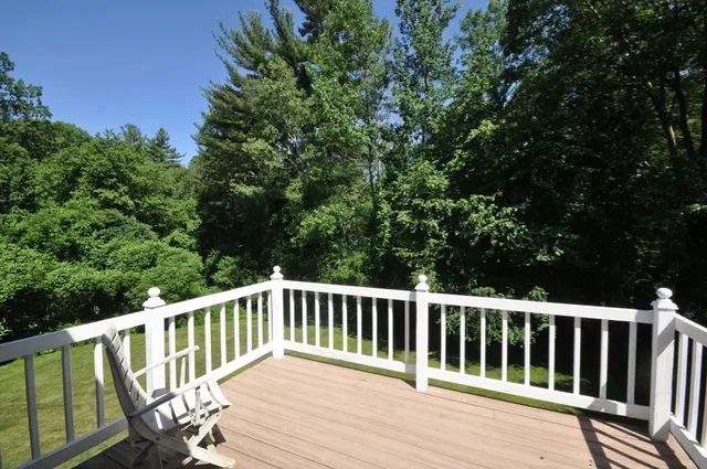 a view of balcony with wooden floor and fence