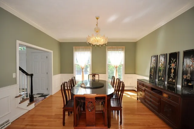 a view of a dining room with furniture and wooden floor