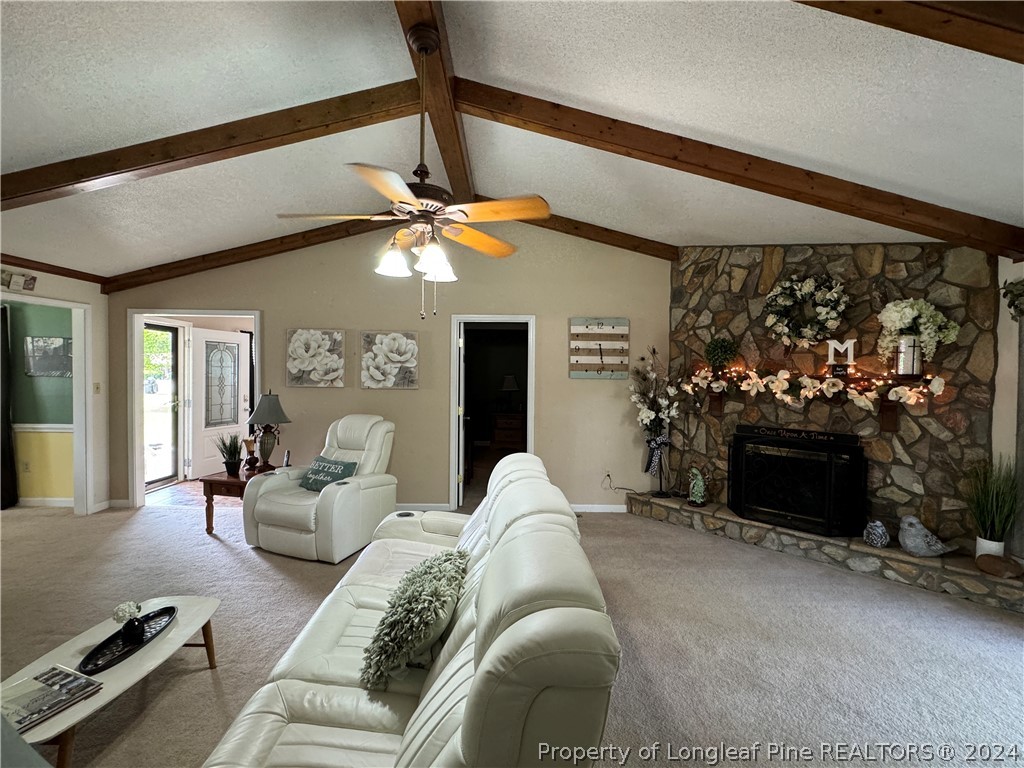 209 Old Farm Road Raeford, NC 28376 - Photo 12 of 45 a living room with furniture a fireplace and a flat screen tv