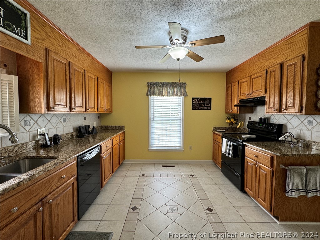 209 Old Farm Road Raeford, NC 28376 - Photo 18 of 45 a kitchen with stainless steel appliances granite countertop a sink stove cabinets and refrigerator