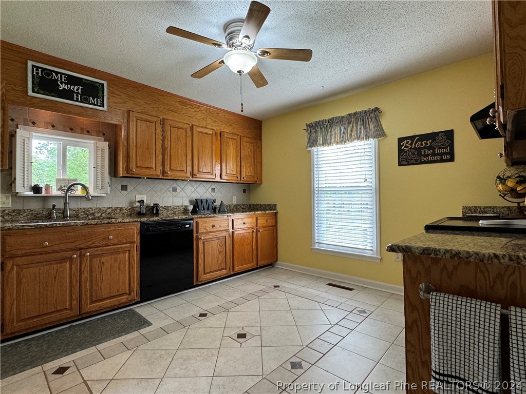 209 Old Farm Road Raeford, NC 28376 - Photo 19 of 45 a kitchen with stainless steel appliances granite countertop a stove sink and cabinets