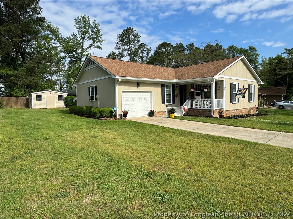 209 Old Farm Road Raeford, NC 28376 - Photo 2 of 45 a front view of a house with a yard and trees