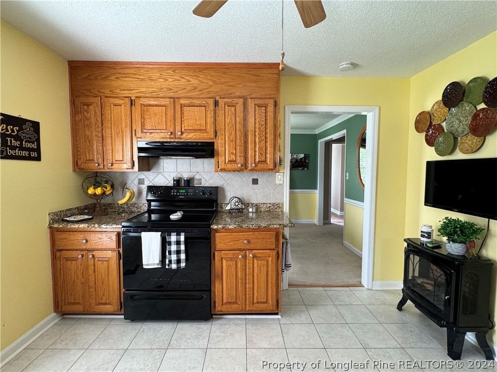 209 Old Farm Road Raeford, NC 28376 - Photo 21 of 45 a kitchen with stainless steel appliances granite countertop a stove and a refrigerator