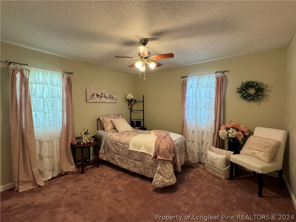 209 Old Farm Road Raeford, NC 28376 - Photo 24 of 45 a bedroom with a bed and a chair
