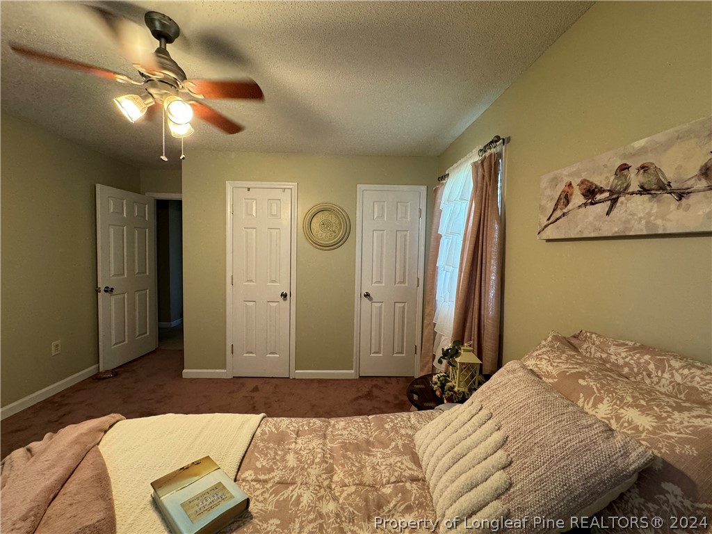209 Old Farm Road Raeford, NC 28376 - Photo 25 of 45 a bedroom with a bed and a chandelier