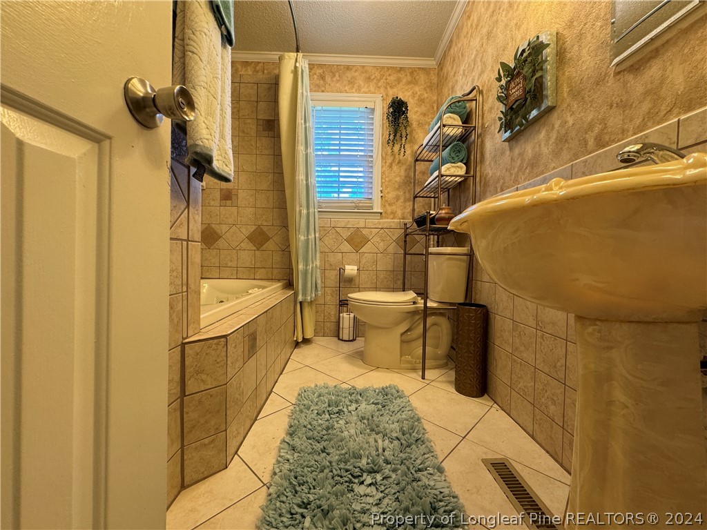 209 Old Farm Road Raeford, NC 28376 - Photo 30 of 45 a bathroom with a sink toilet and shower