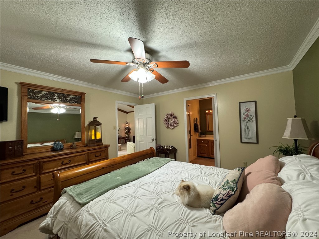 209 Old Farm Road Raeford, NC 28376 - Photo 33 of 45 a bedroom with a bed and a flat tv screen on dresser