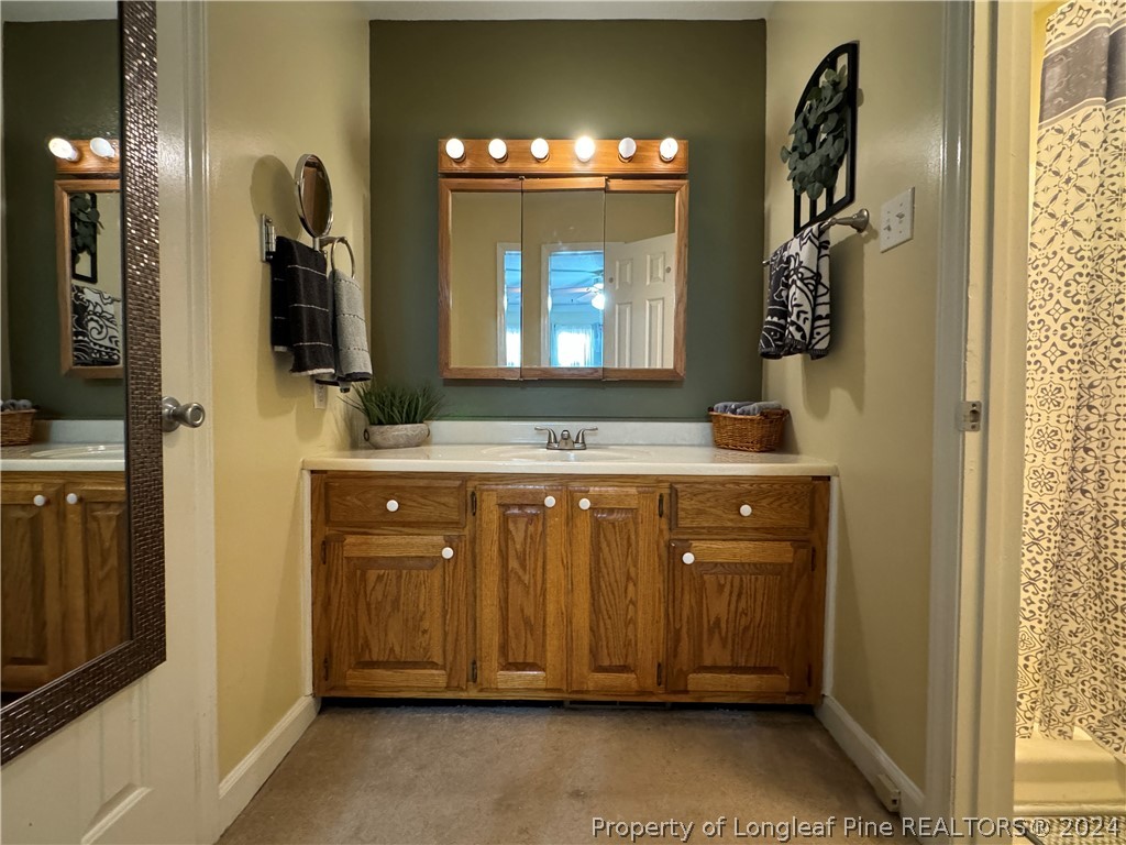 209 Old Farm Road Raeford, NC 28376 - Photo 35 of 45 a bathroom with a sink and a mirror