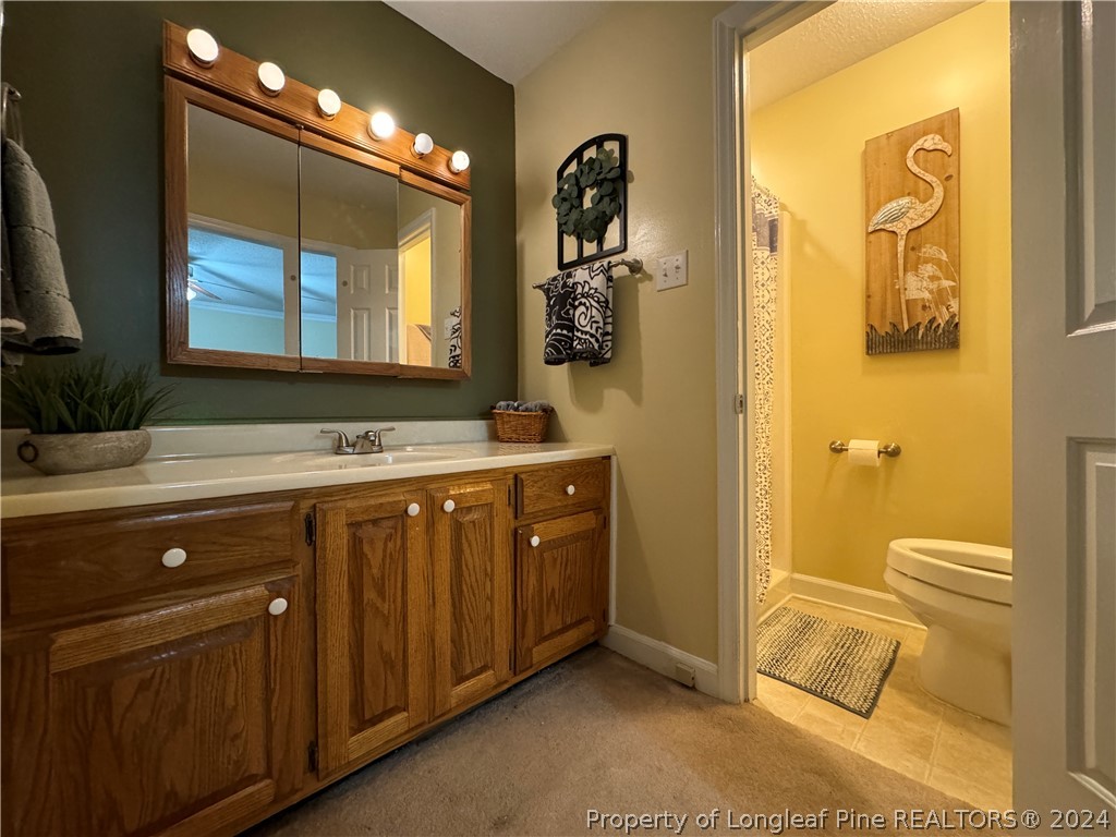 209 Old Farm Road Raeford, NC 28376 - Photo 36 of 45 a spacious bathroom with a double vanity sink and a mirror