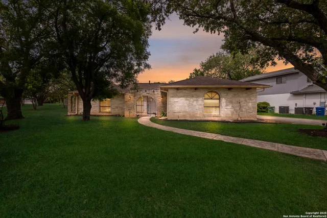 a front view of house with yard and green space