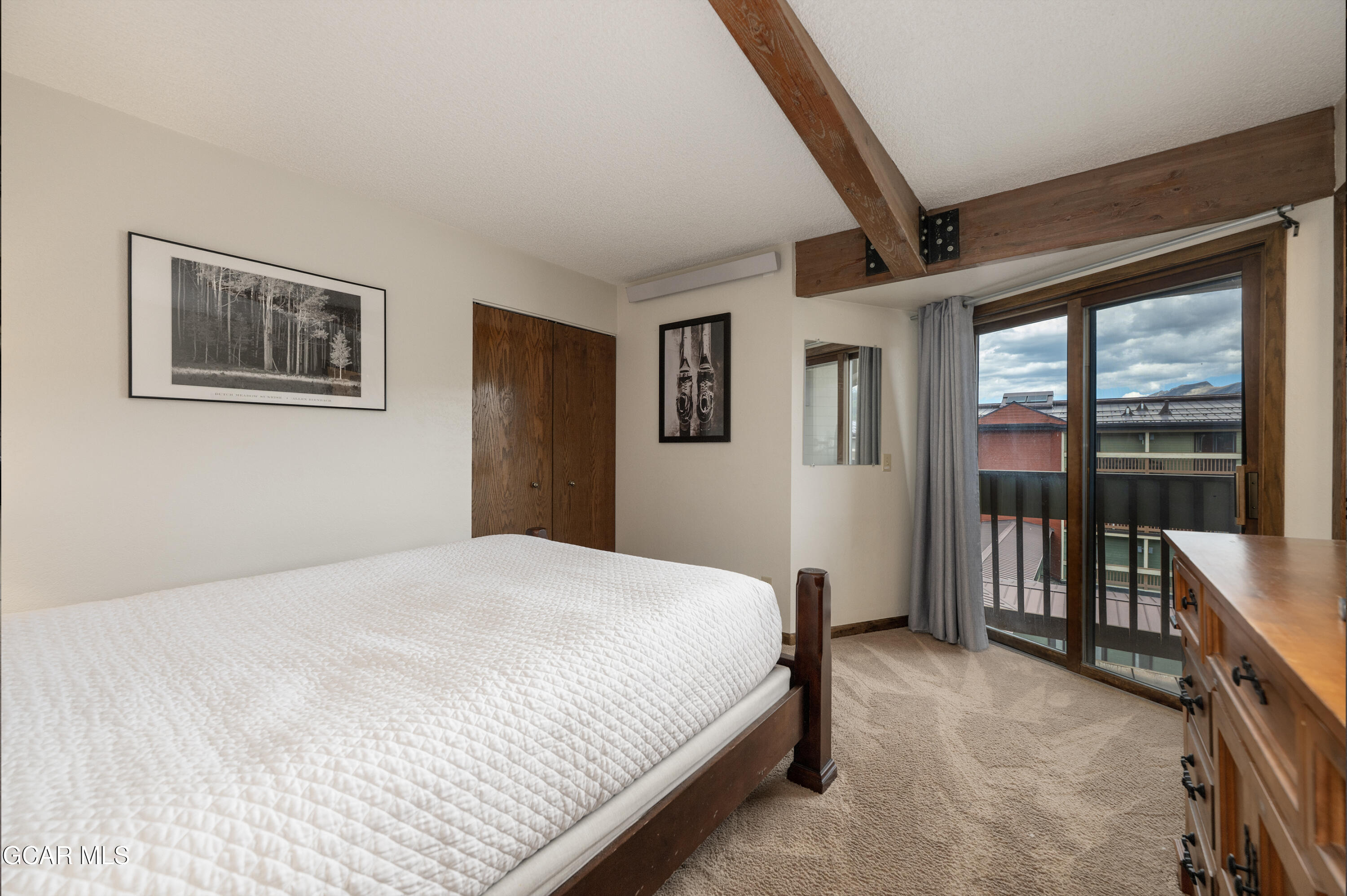 490 Kings Crossing Road, Unit 331 Winter Park, CO 80482 - Photo 11 of 38 a bedroom with a large bed and a window