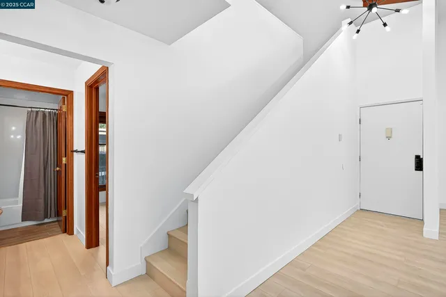 a view of a hallway with wooden floor and entryway