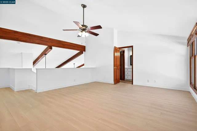 a view of an empty room with a ceiling fan