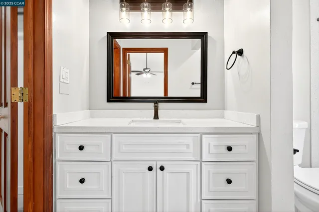 a bathroom with a sink vanity and mirror