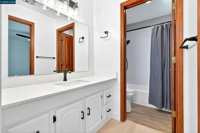 a bathroom with a sink a mirror and a shower