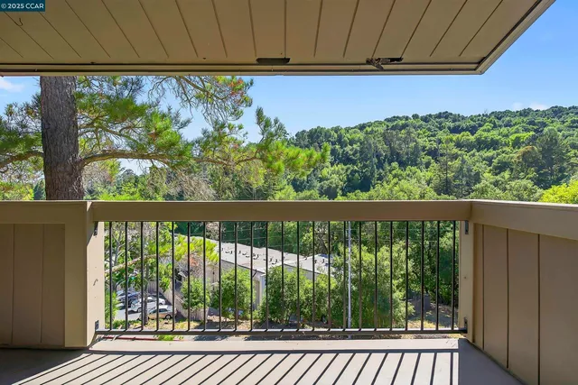 a view of a balcony with wooden floor