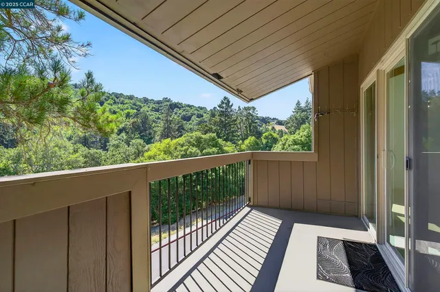 a view of a balcony with wooden floor and outdoor space