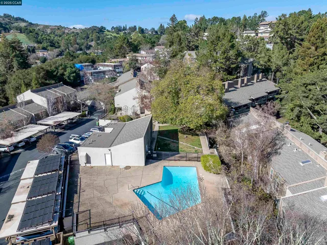 an aerial view of a house with a yard