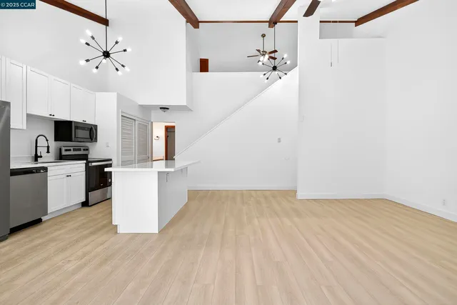 a view of a kitchen with microwave and cabinets