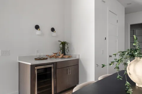 a bathroom with a granite countertop sink and a toilet