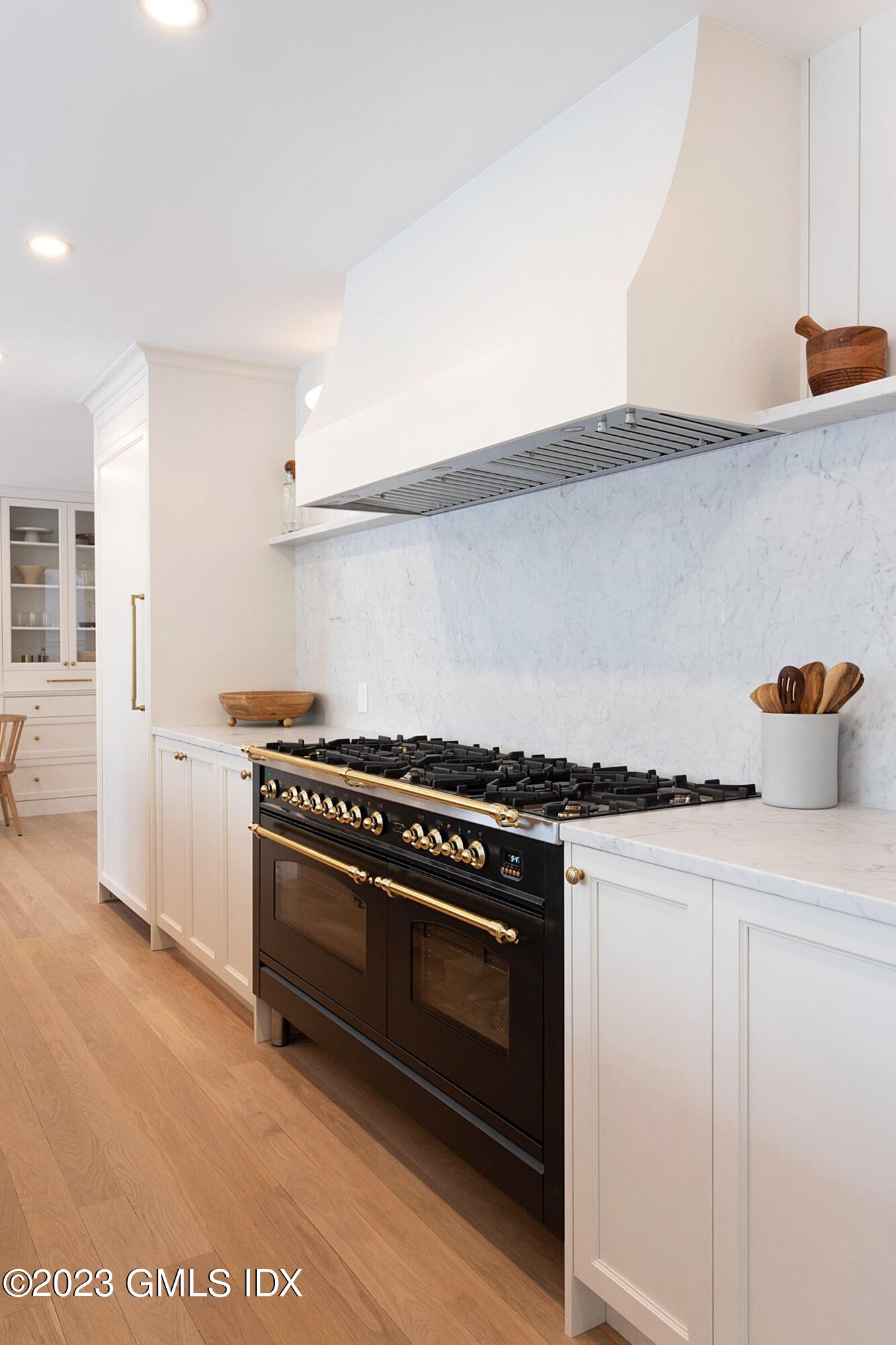 48 Old Mill Road Greenwich, CT 06831 - Photo 14 of 47 a kitchen with stainless steel appliances a stove and white cabinets