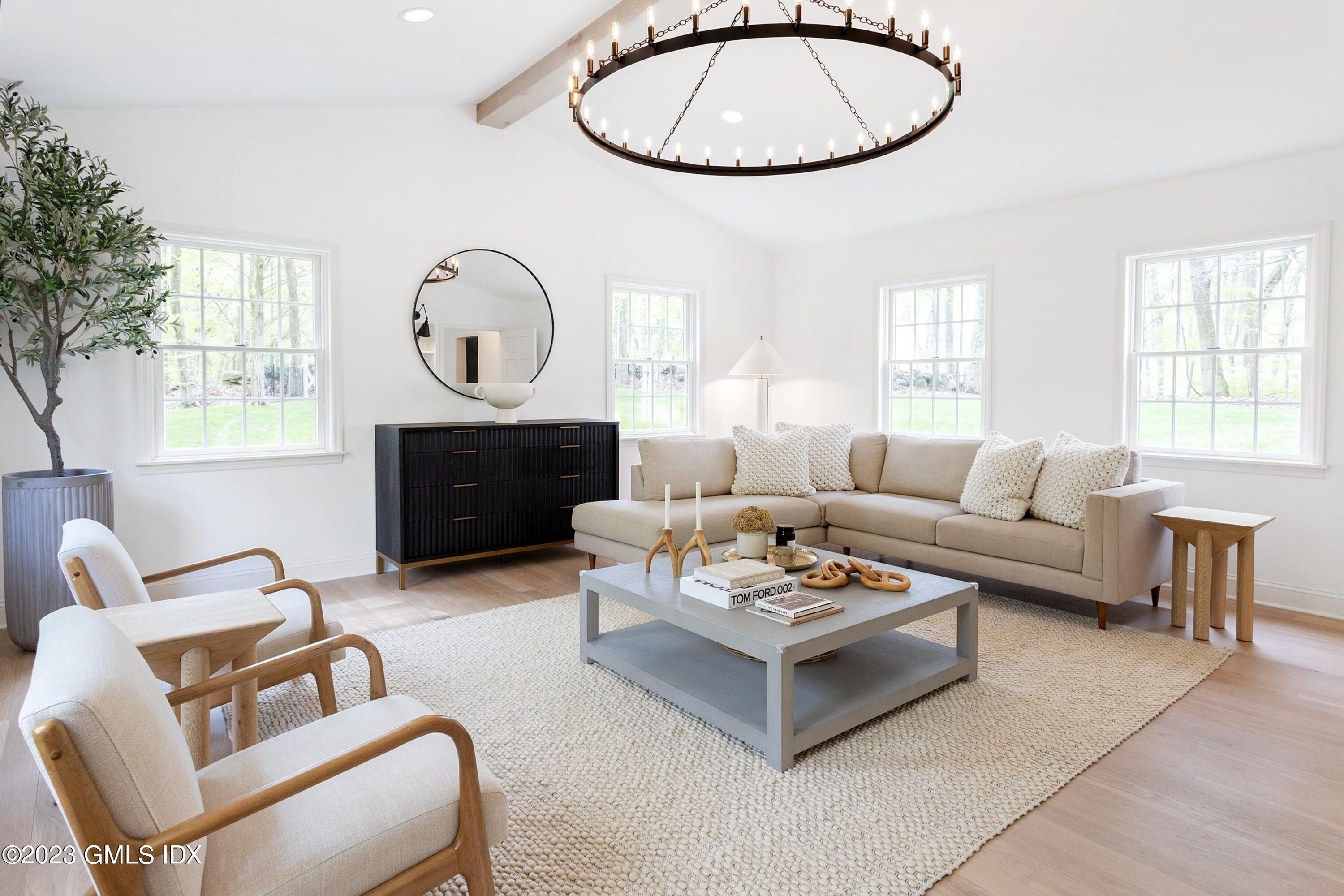 48 Old Mill Road Greenwich, CT 06831 - Photo 18 of 47 a living room with furniture a large window and a fireplace