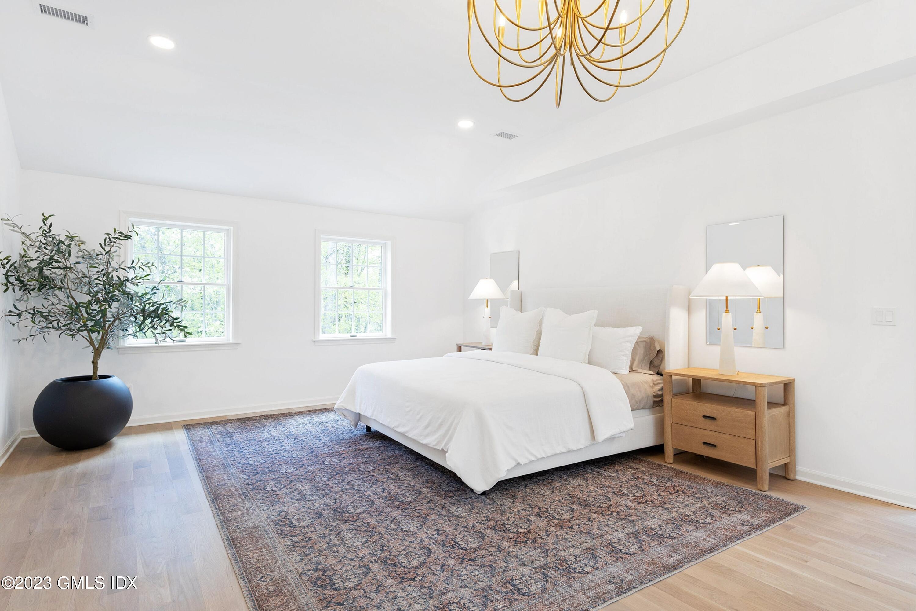 48 Old Mill Road Greenwich, CT 06831 - Photo 21 of 47 a bedroom with a bed and a chandelier